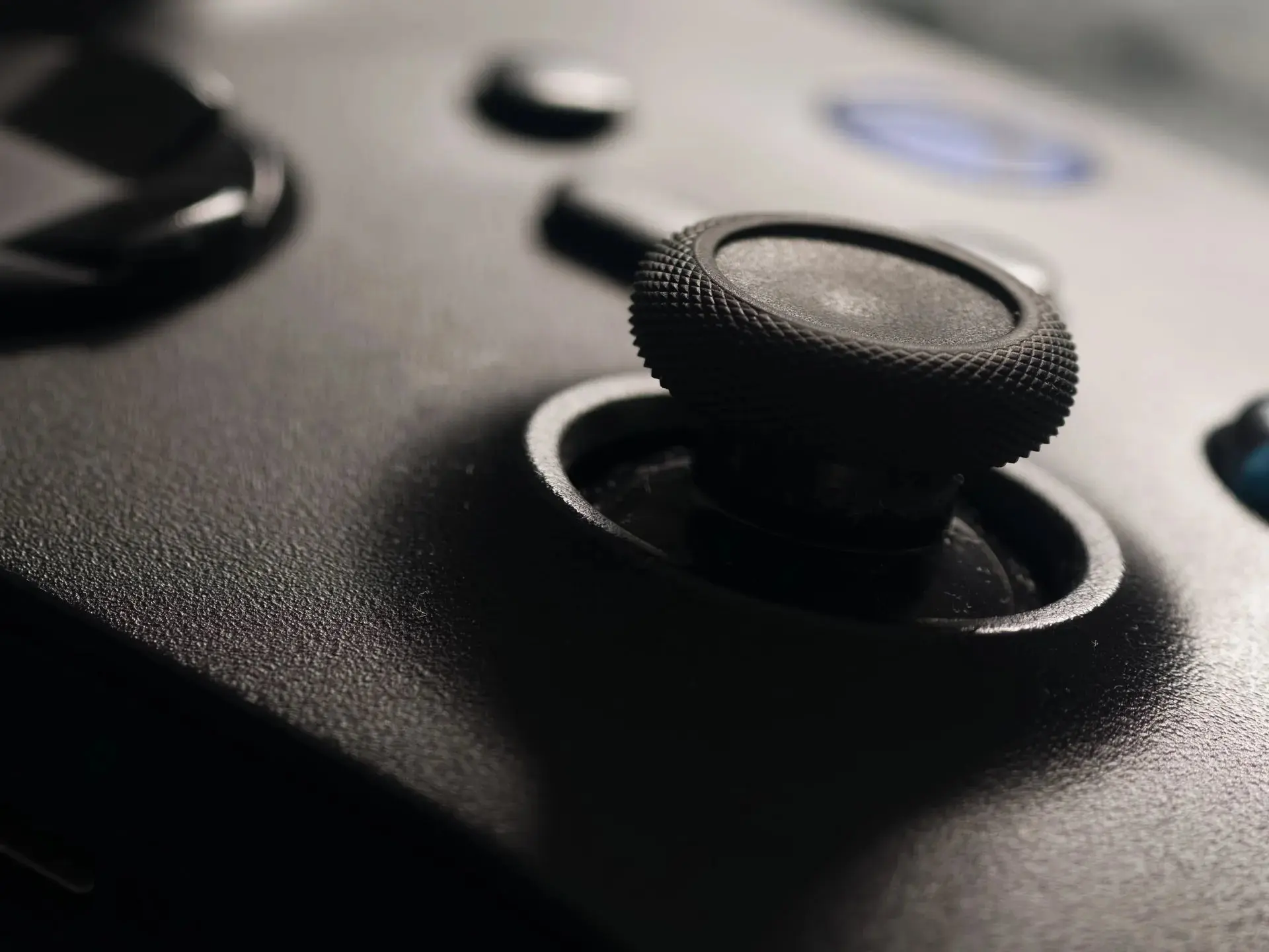 Game console and controller beside a television